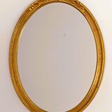Antique oval-shaped gilded mirror
