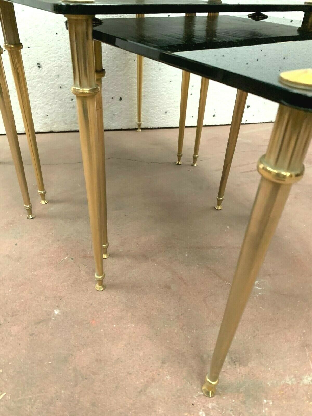 Pull out tables in brass and black glass XX century