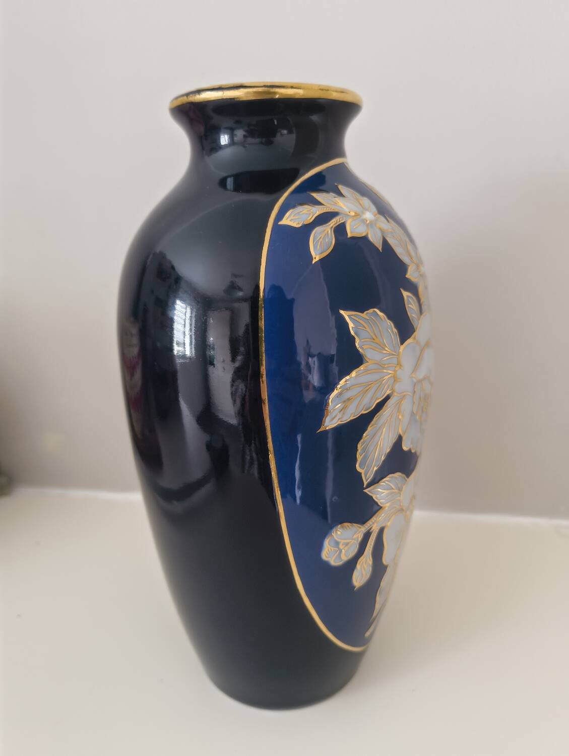 Cobalt blue porcelain vase from Limoges, France with floral pattern.