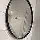 Round mirror 75cm in diameter with a black frame.