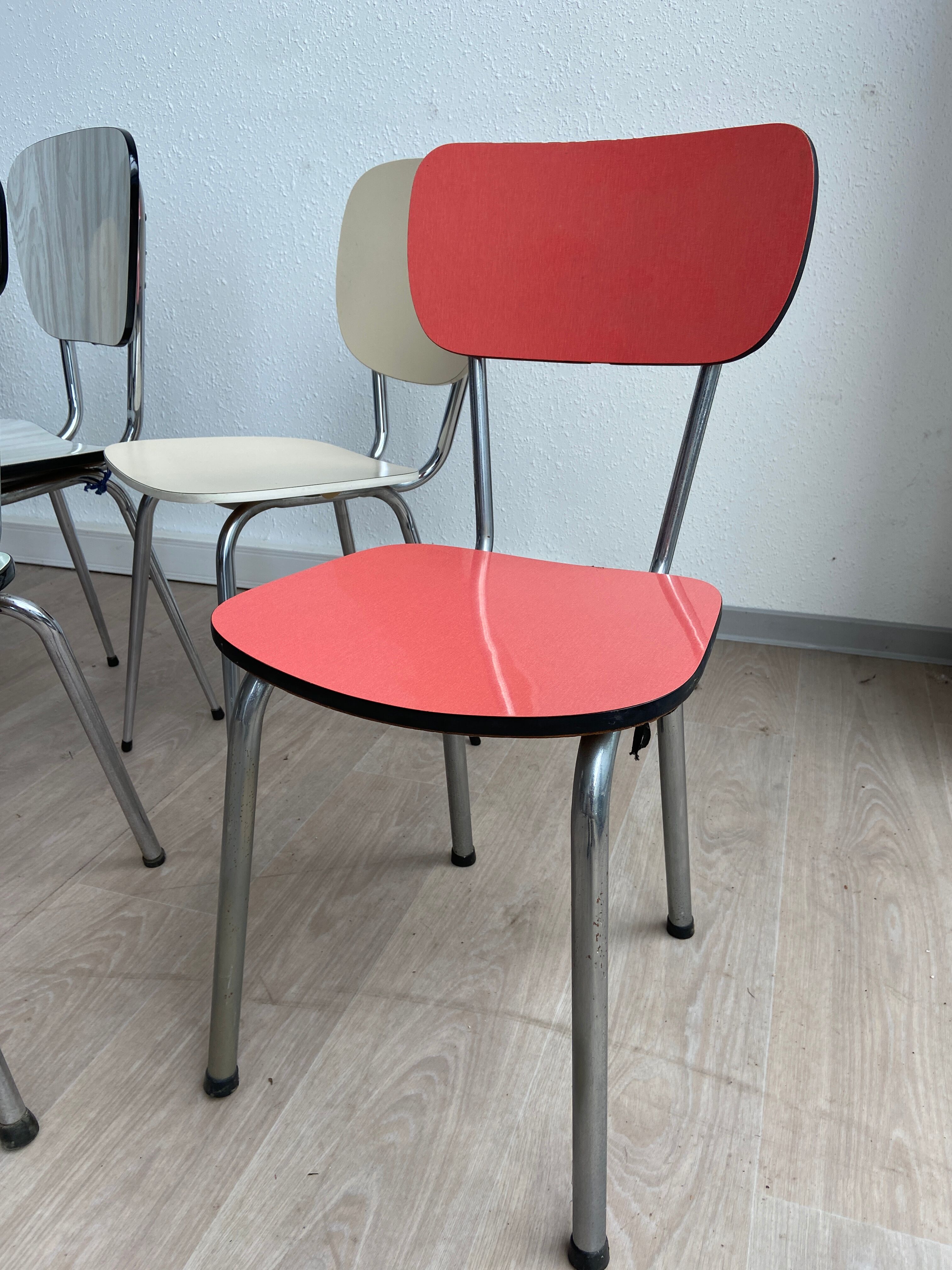 10 mismatched multicolored Formica chairs 60s