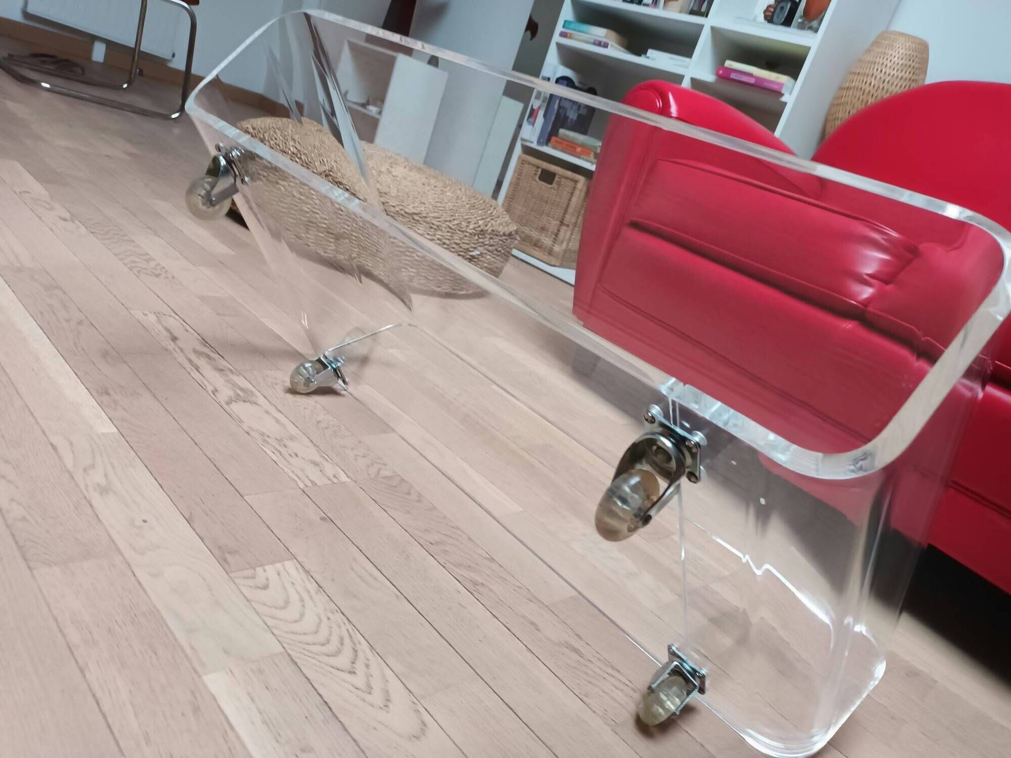 Design coffee table from Habitat in transparent plexiglass, mounted on wheels.