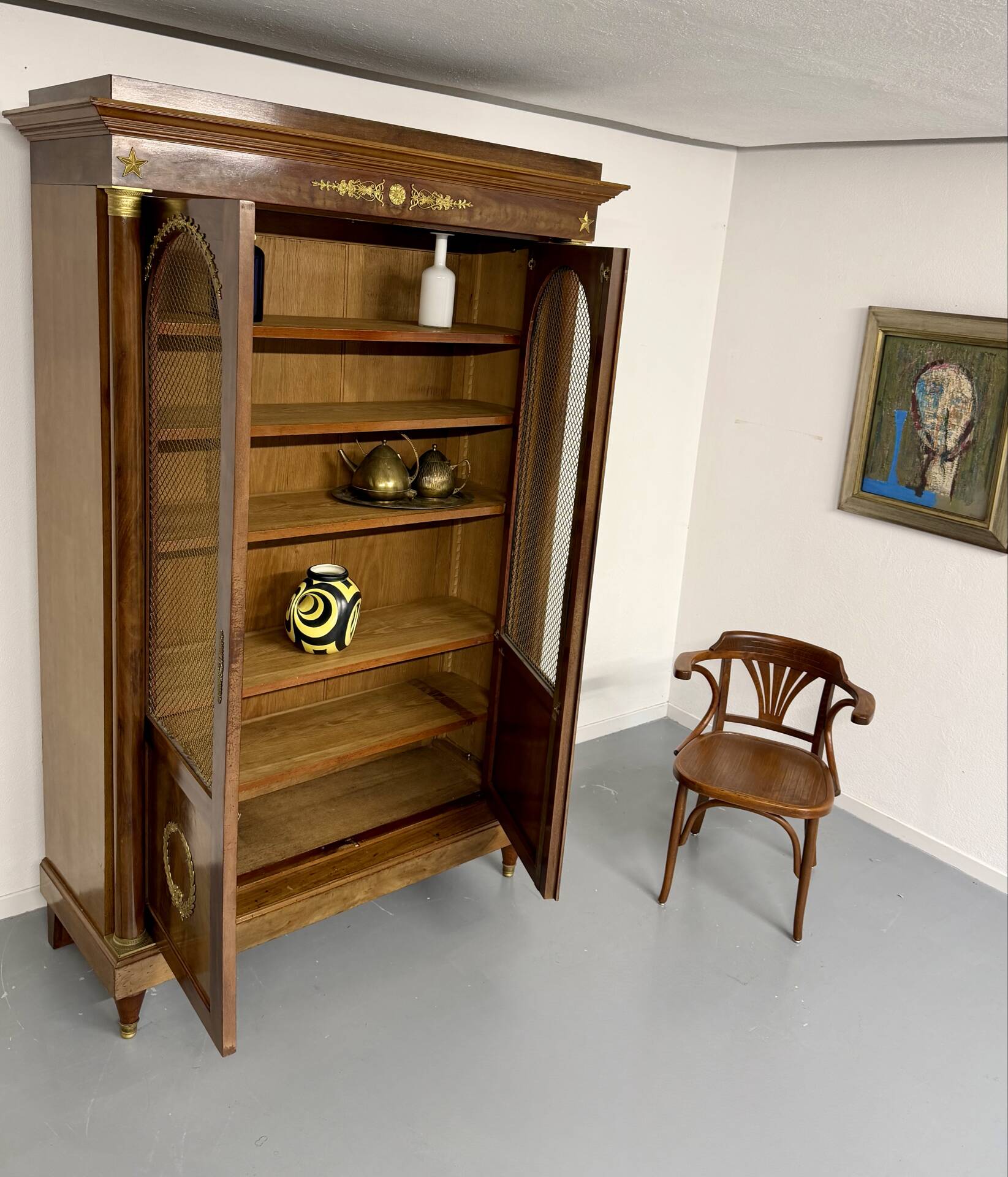 Large Empire-style library in wood with gilded bronze ornaments.