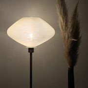 Table lamp with a vintage glass globe and saucer and a golden foot