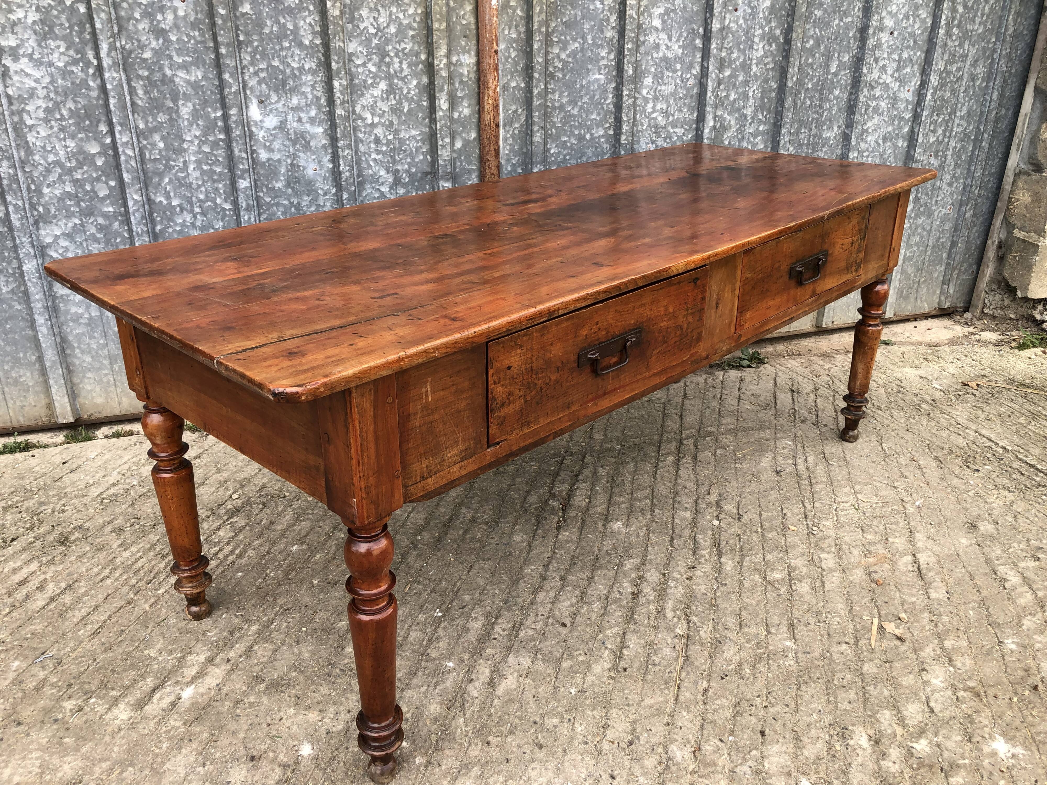 Old farmhouse table in solid cherry wood with 2 front drawers.