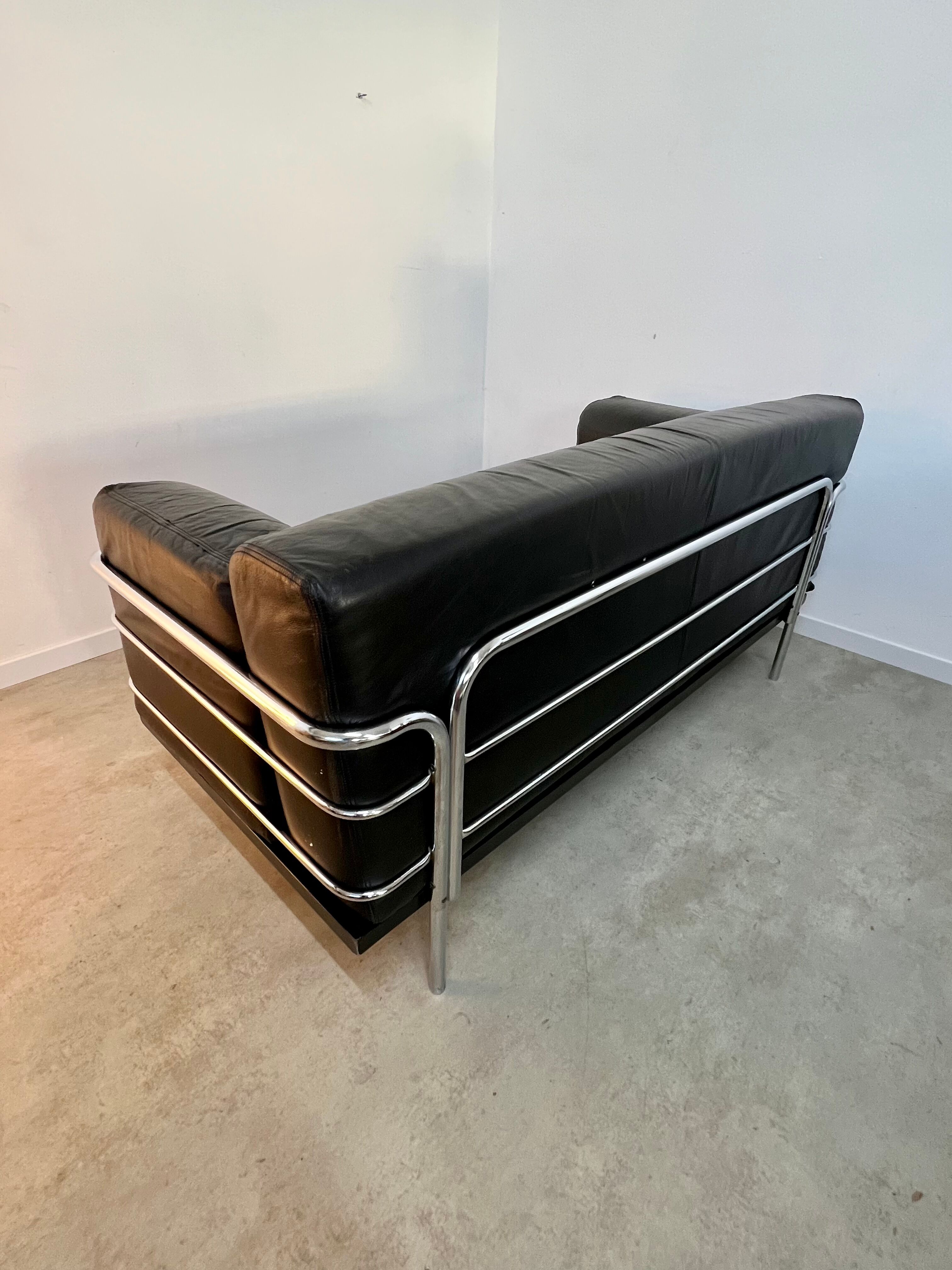 Old vintage leather and tubular metal sofa, design 70s