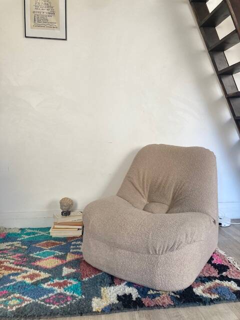 Vintage armchair reupholstered in boucle fabric.