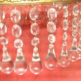 circular chandelier with a brass frame equipped with crystal drops