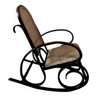 Curved wooden rocking chair with caning