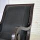 1970s, vintage armchair with footstool, black furniture leather.