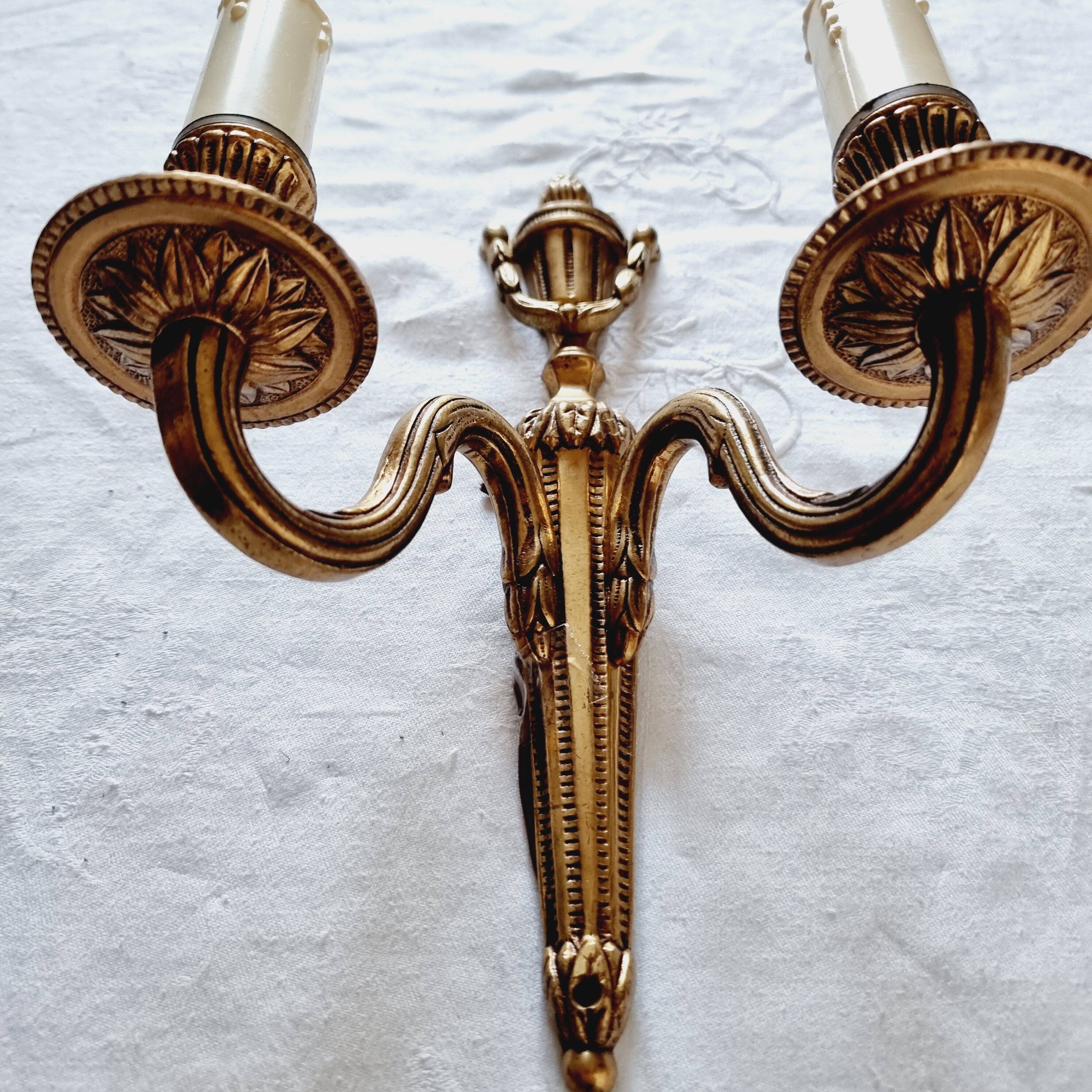 French Empire-style wall sconce or chandelier in bronze with an antique gold patina.