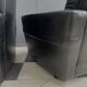 2 Black leather arm chairs 1960s on wheels