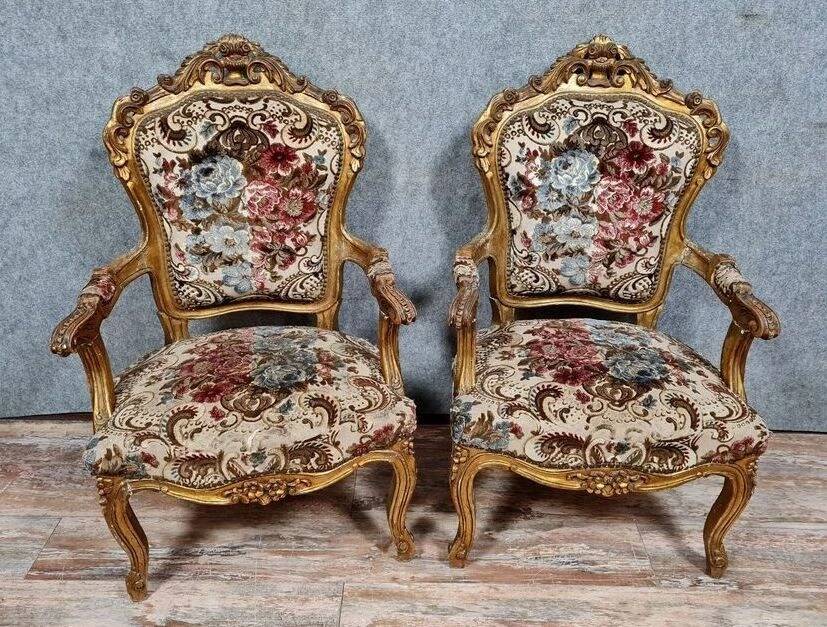 Pair of carved and gilded cabriolet armchairs in the Louis XV style.