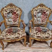 Pair of carved and gilded cabriolet armchairs in the Louis XV style.
