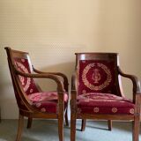 Paire de fauteuils Empire bordeaux à motif lyre , pieds sabre, accotoirs sculptés têtes de dauphin X
