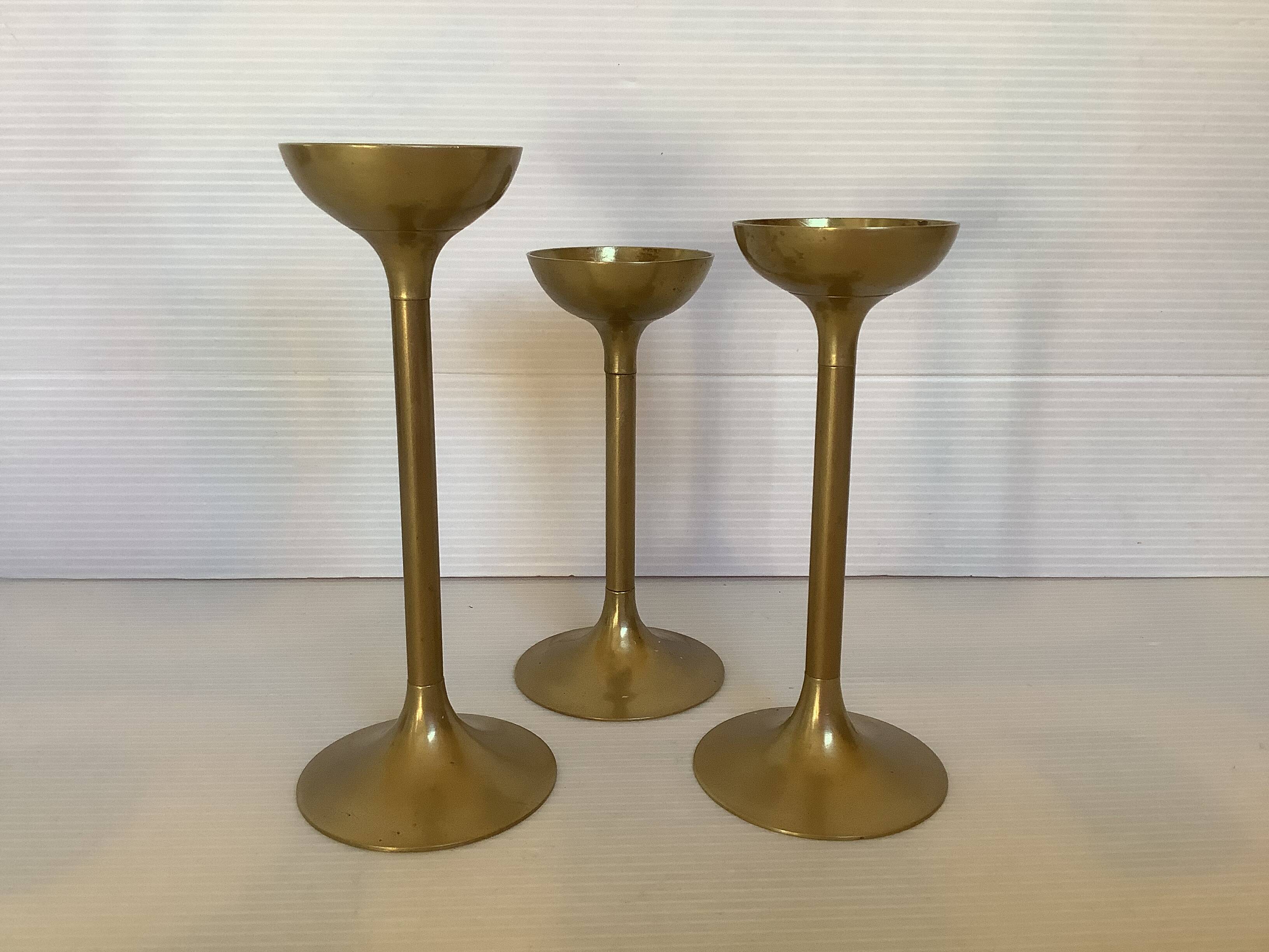 Trio of brass tulip foot candle holders