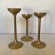 Trio of brass tulip foot candle holders