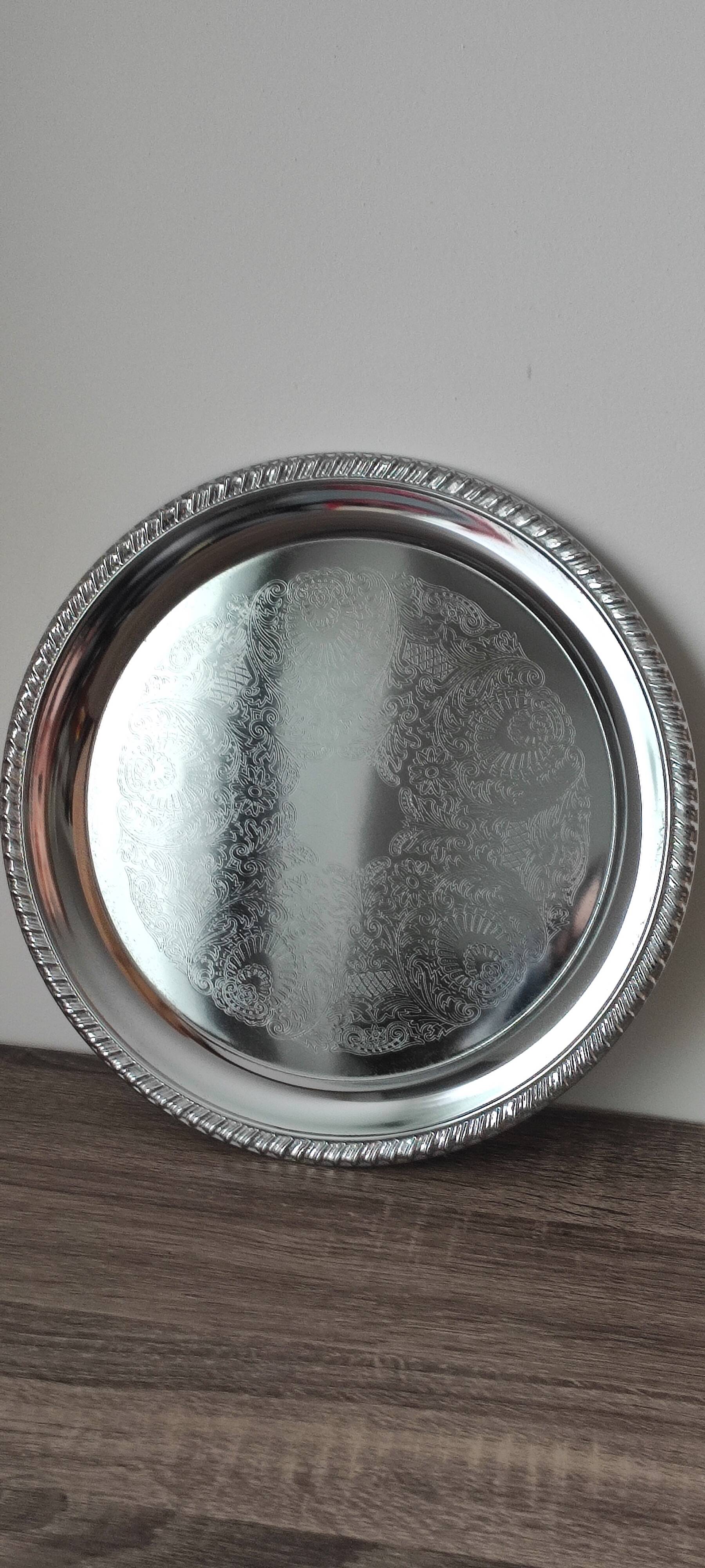 Silver-plated metal dish with a 1980s pattern.
