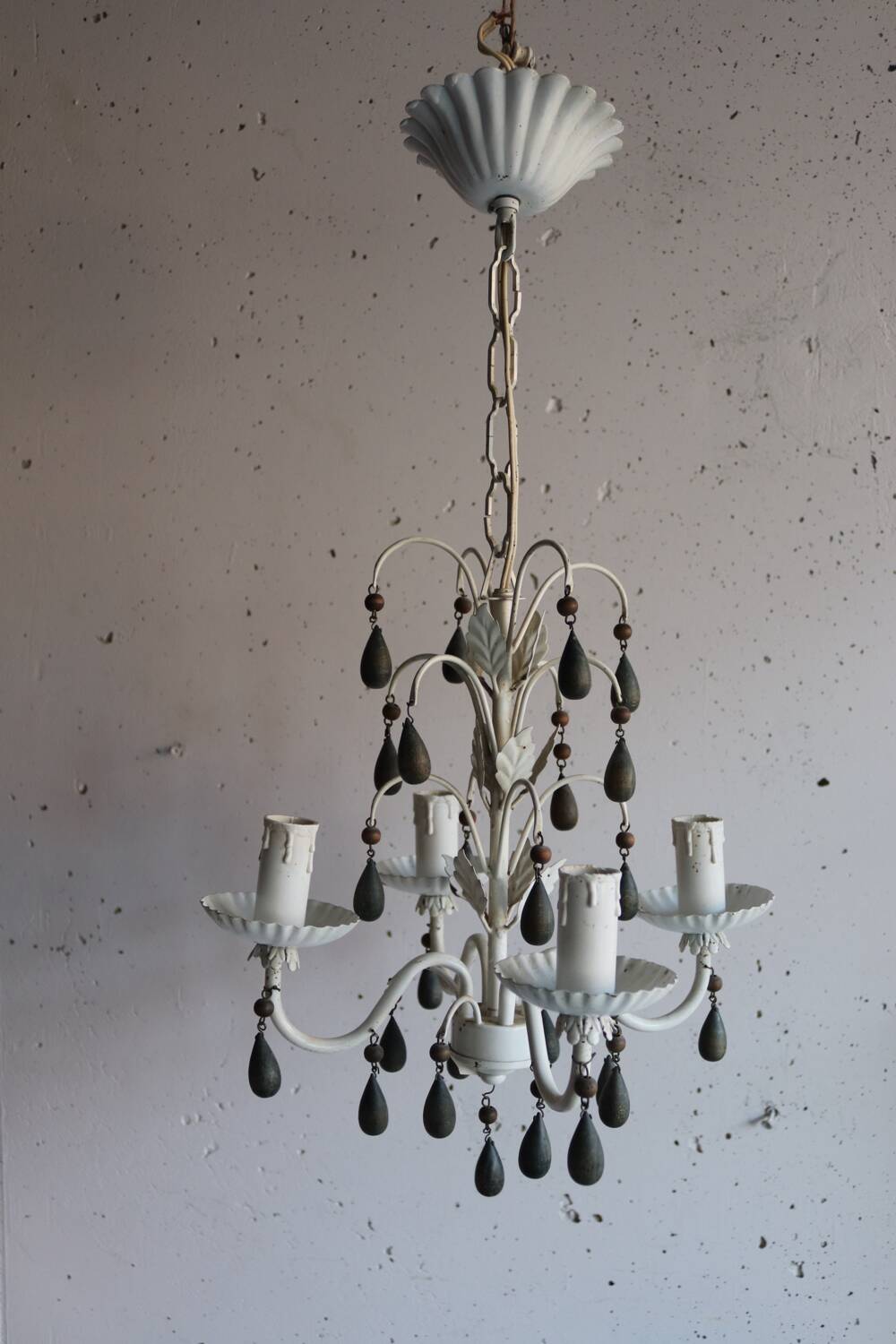 Antique white lacquered metal chandelier with wooden pendants.