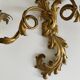 Pair of Italian Hollywood Regency wall lights in iron and gilded sheet metal.