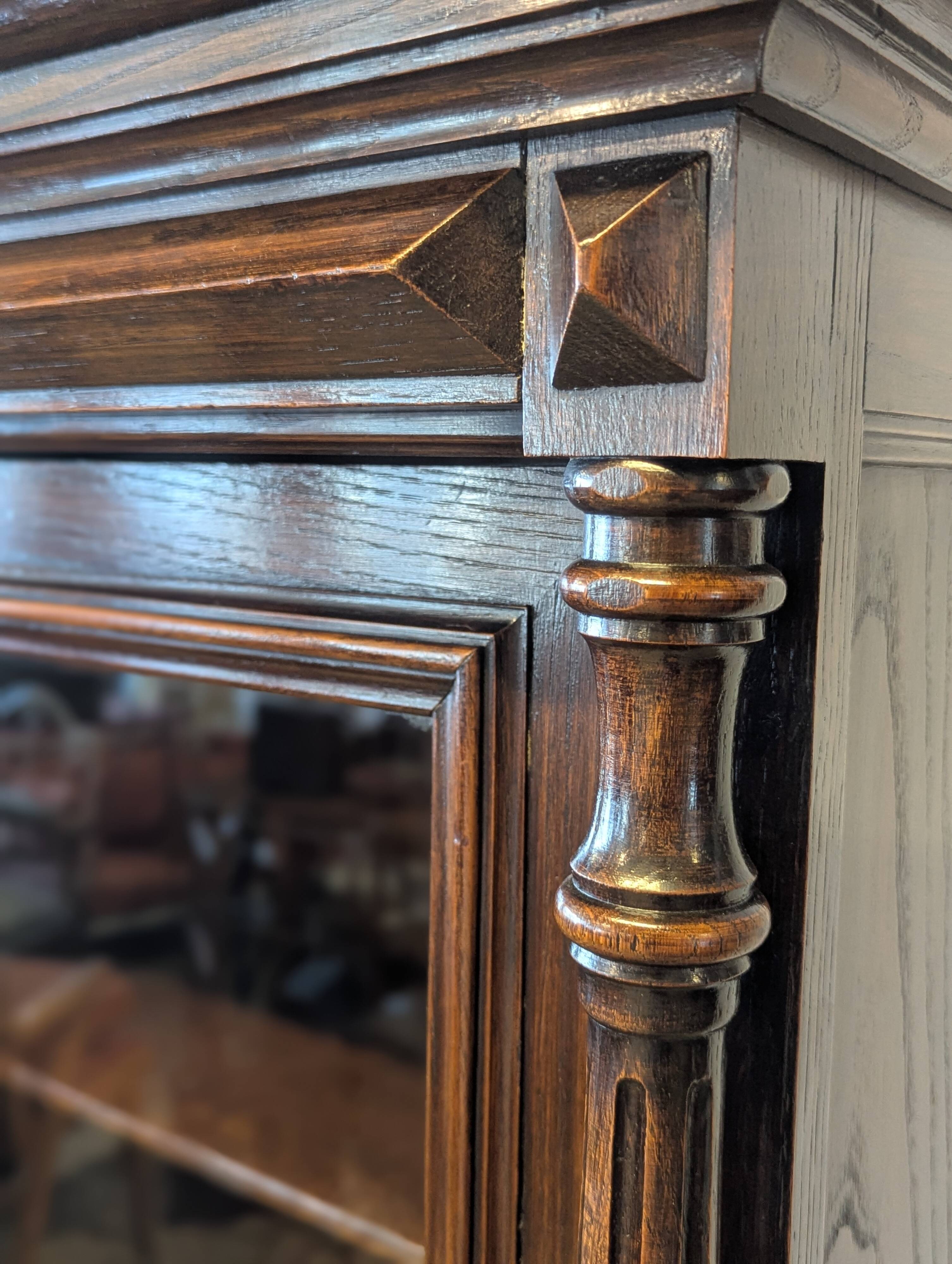 Two-body display cabinet in oak, Henri II style.