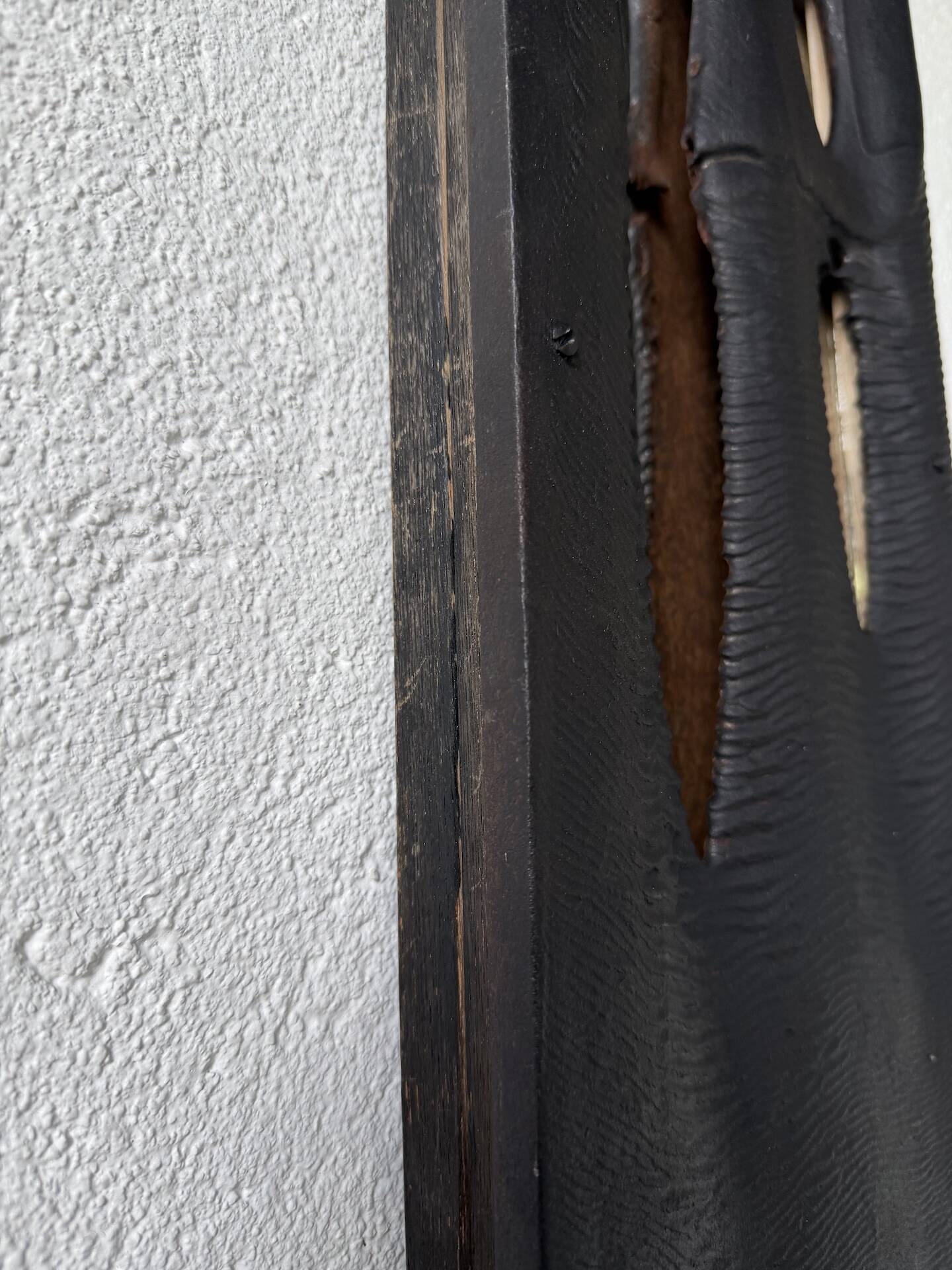 Brutalist hammered mirror, free-form, patinated metal.