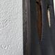 Brutalist hammered mirror, free-form, patinated metal.