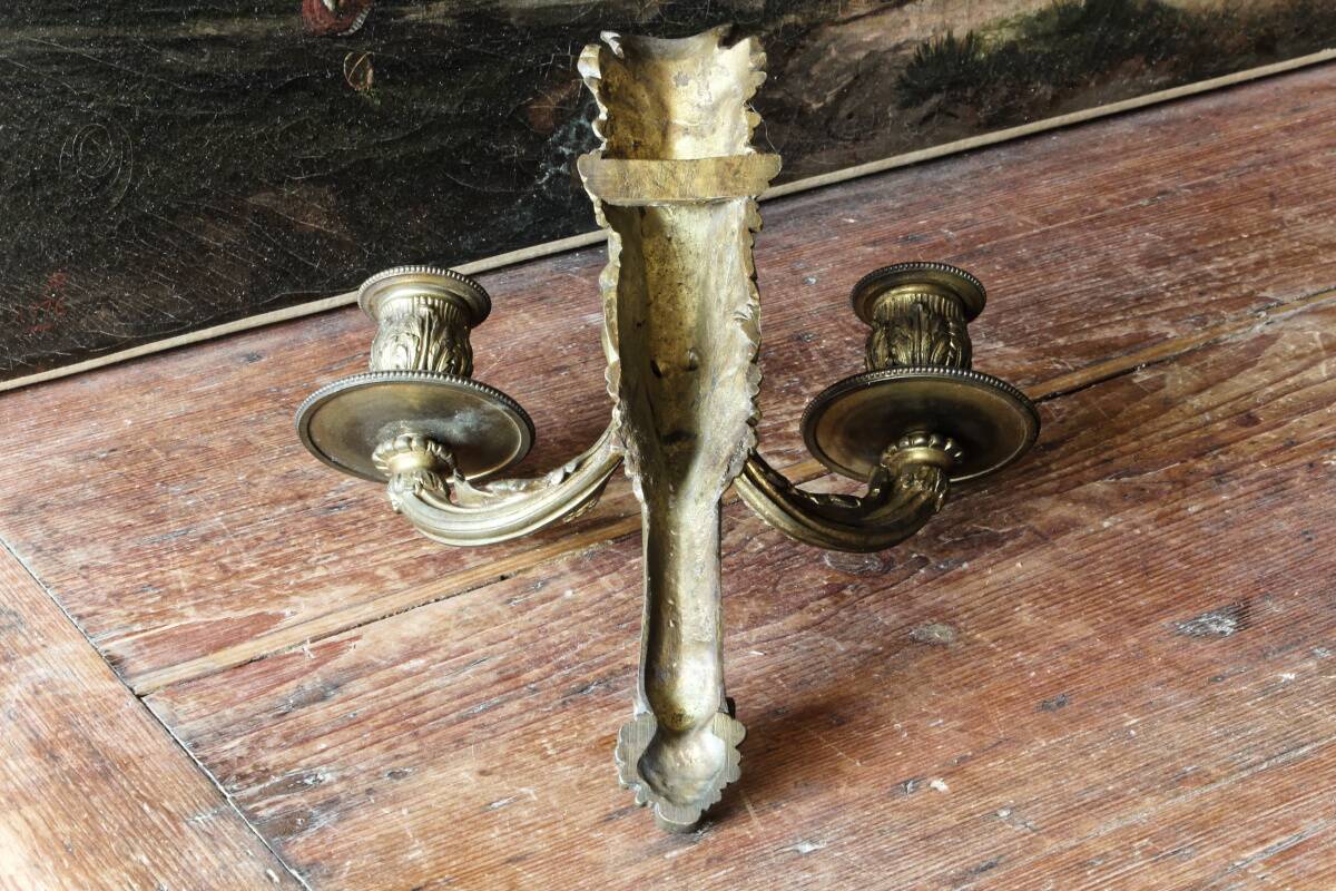 Monobloc gilded bronze wall light, grotesque satyr, two lights.