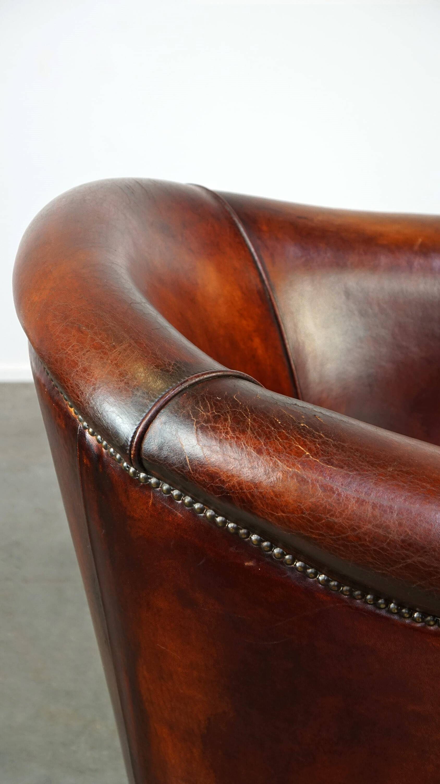 Very luxurious dark brown sheepskin club chair with a more than beautiful patina