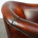 Very luxurious dark brown sheepskin club chair with a more than beautiful patina