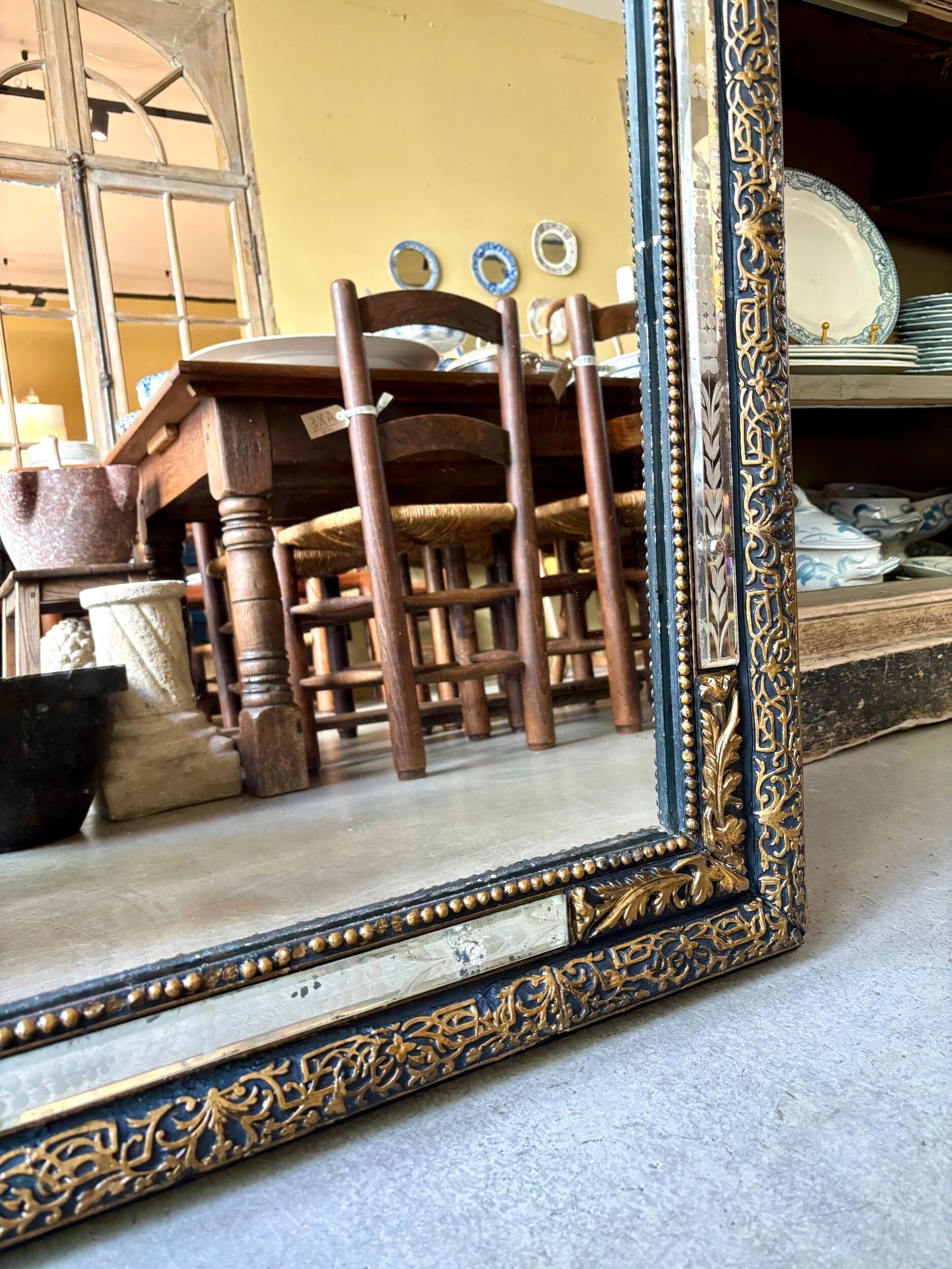 Rectangular Napoleon III mirror in moulded black and gold wood with engraved mirror decoration.