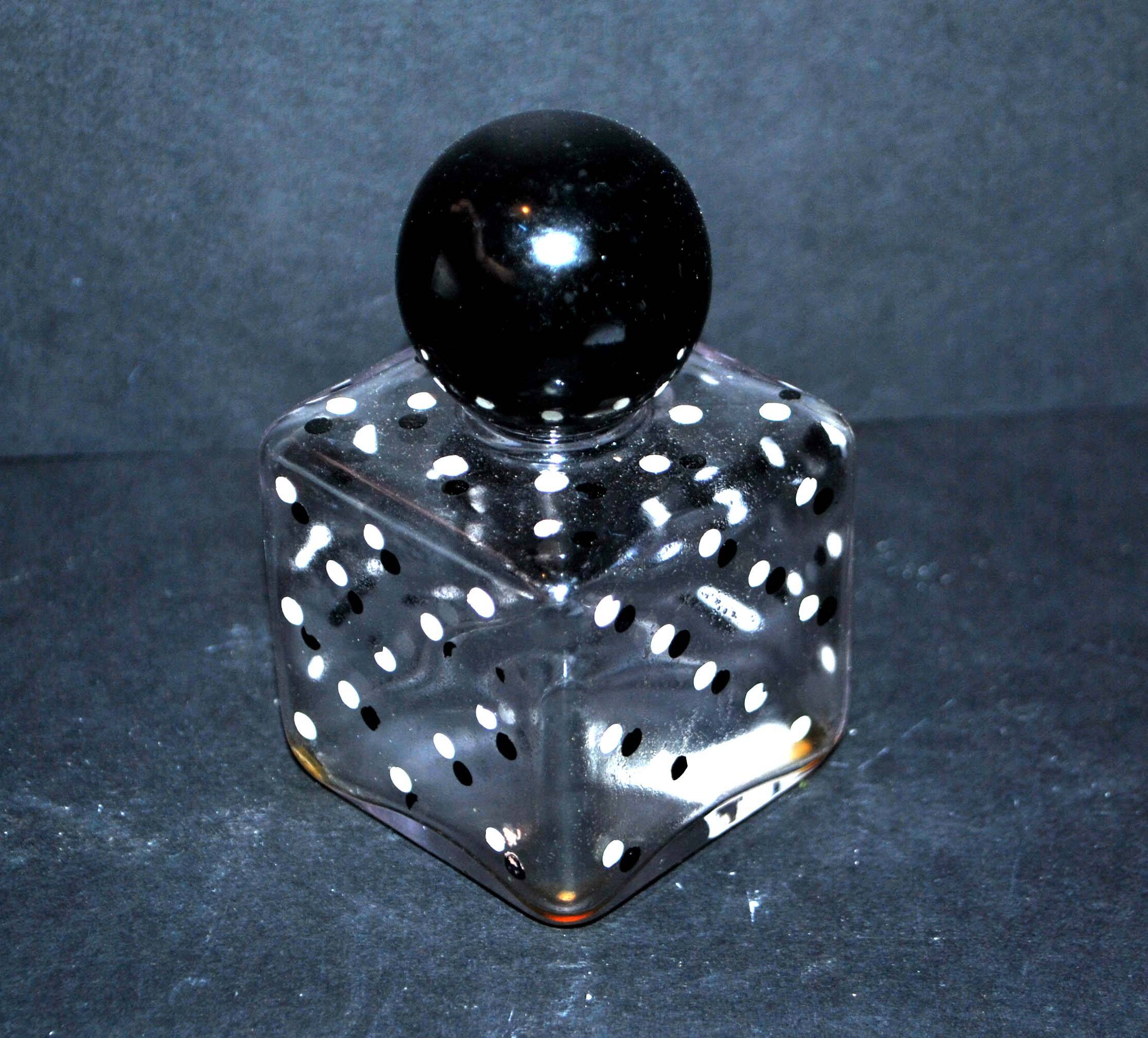 Vintage white and black polka dot glass perfume bottle and round bakelite cap