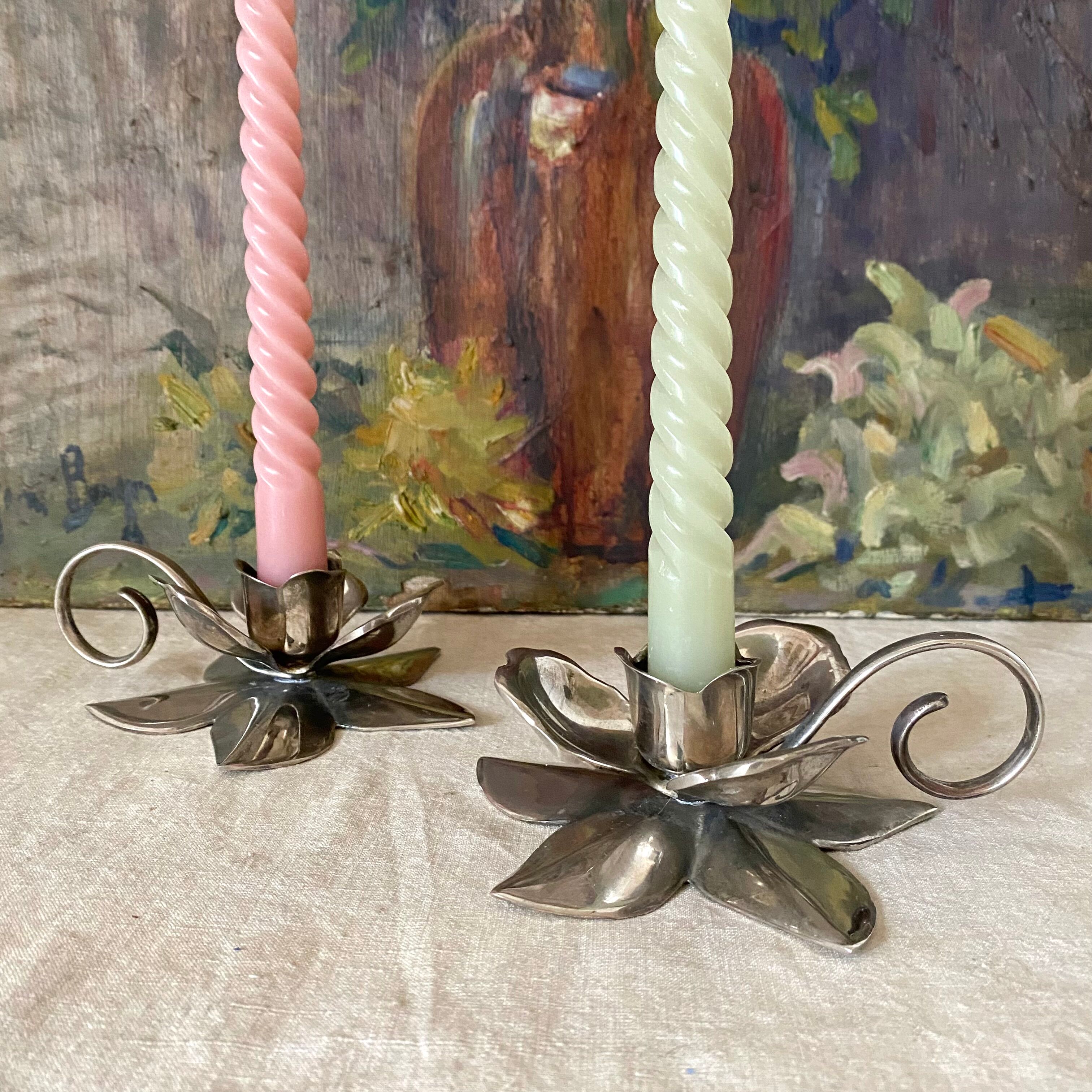 Pair of silver metal flower candle holders