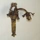 Double wall light in bronze in French Rococo style with white glass shades featuring patterns.