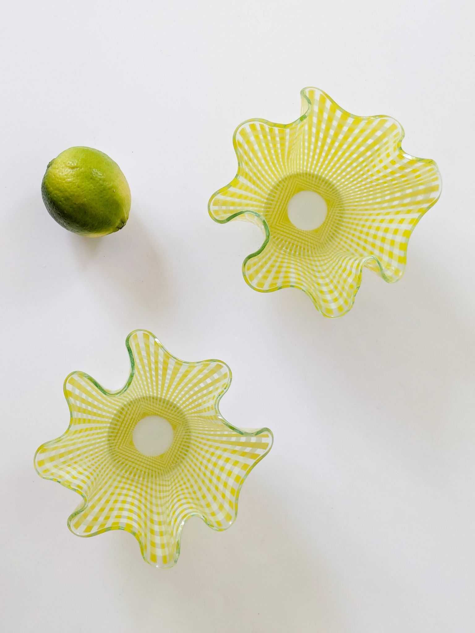 Pair of "Gingham" Chance Brothers cups with yellow checkered pattern and wavy edges.