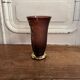 Frosted Shneider vase with pink background enhanced with golden vine leaves