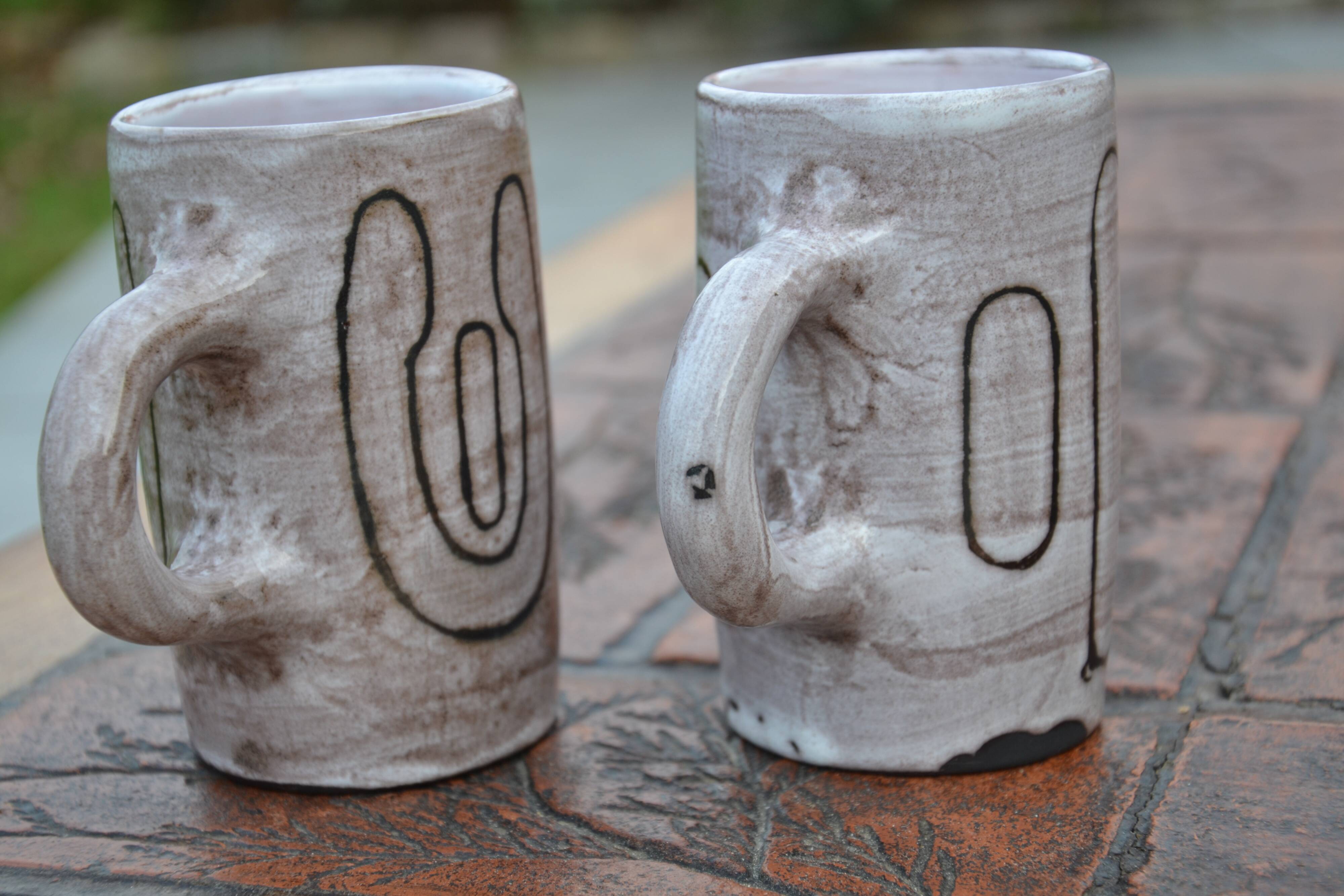 2 ceramic mugs signed db