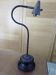 Old desk lamp with a small copper shade and a porcelain base.