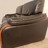 Black leather sofa and wooden armrests