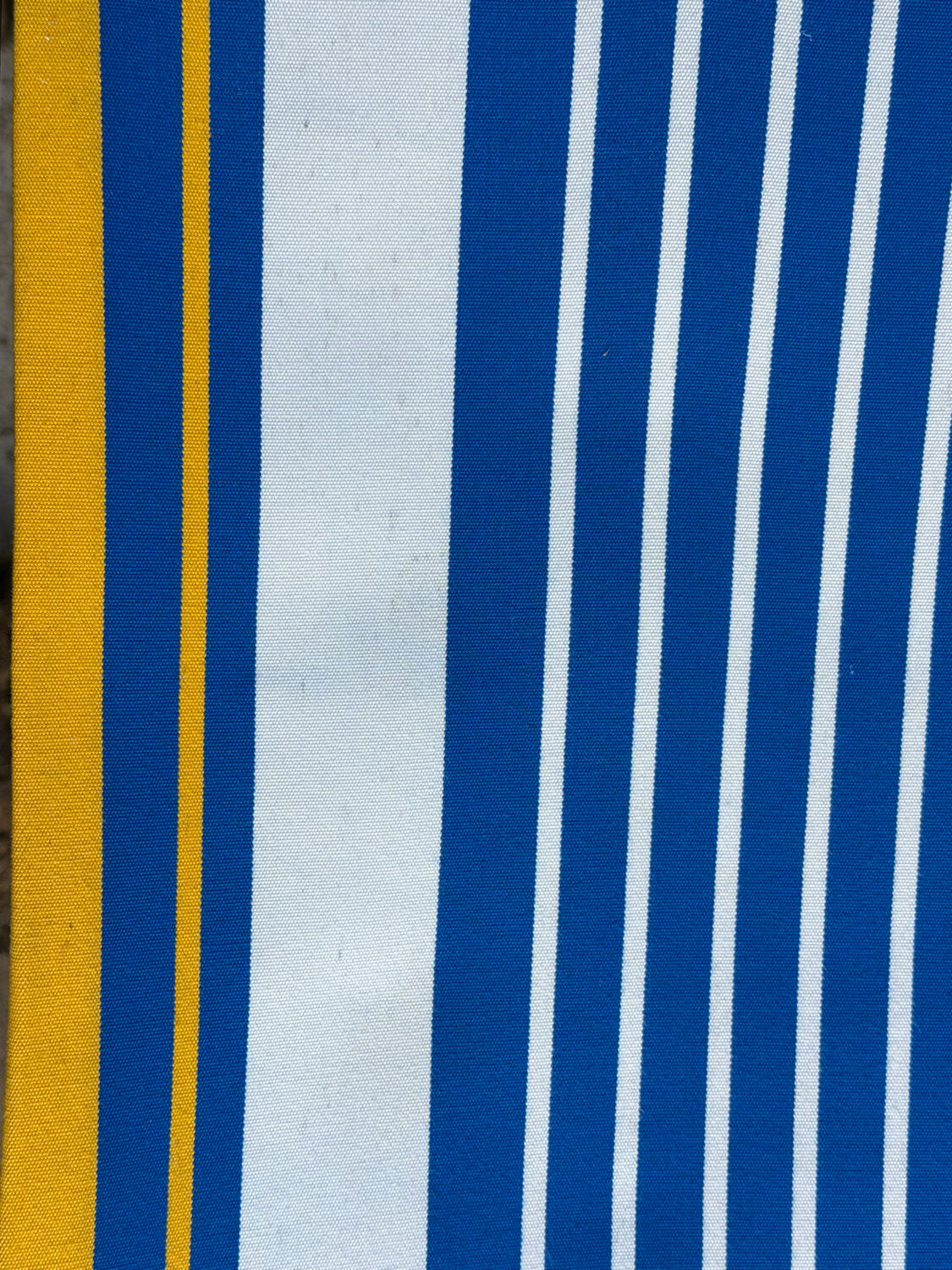 Vintage deck chair with blue and yellow striped fabric, original patina.