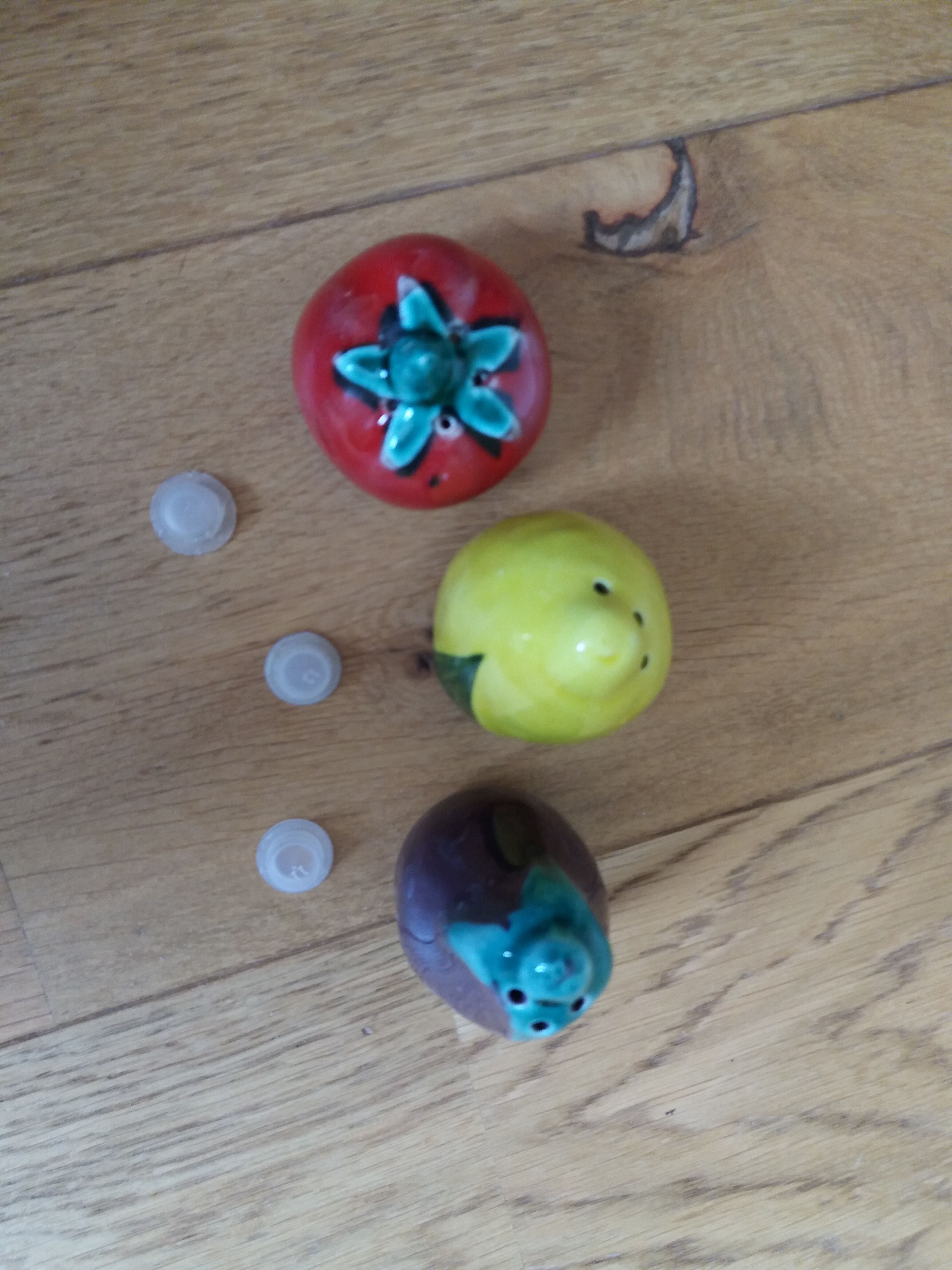 Trio salt shakers pepper vegetables and fruits in slip