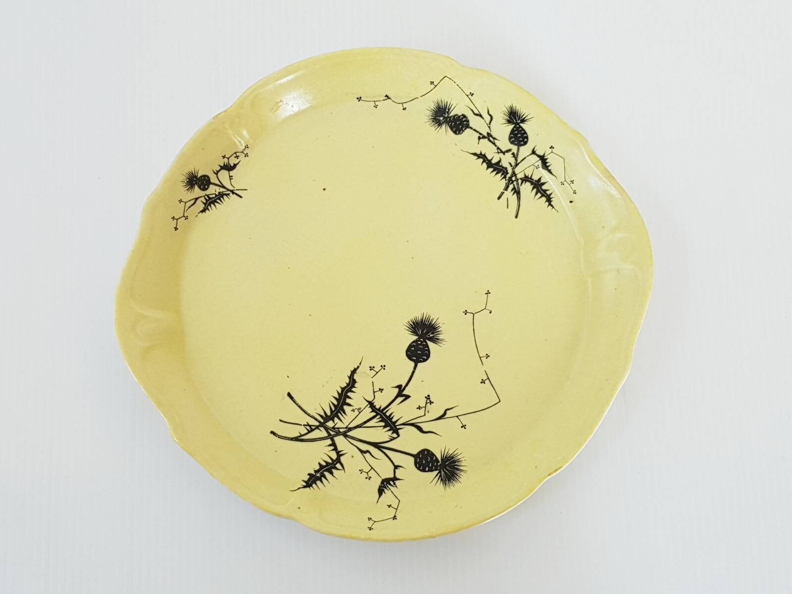 A yellow Art Deco ceramic tobacco service decorated with thistles from the 1920s to 1930s.