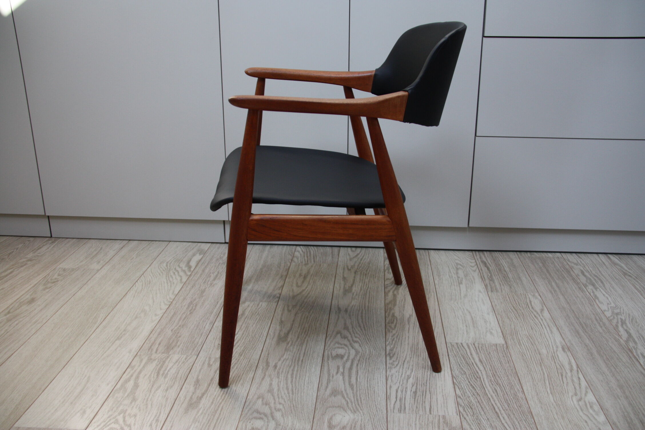 Vintage armchair in teak and black leather model Casina 60s