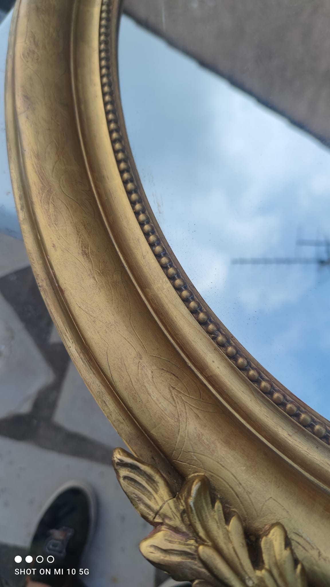 Ovoid mirror with double gilt pediments, circa 1830, 105x66 cm