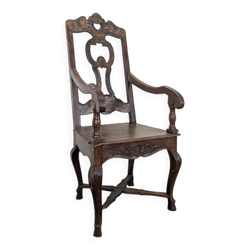Louis XIV armchair in carved walnut with a high openwork backrest.