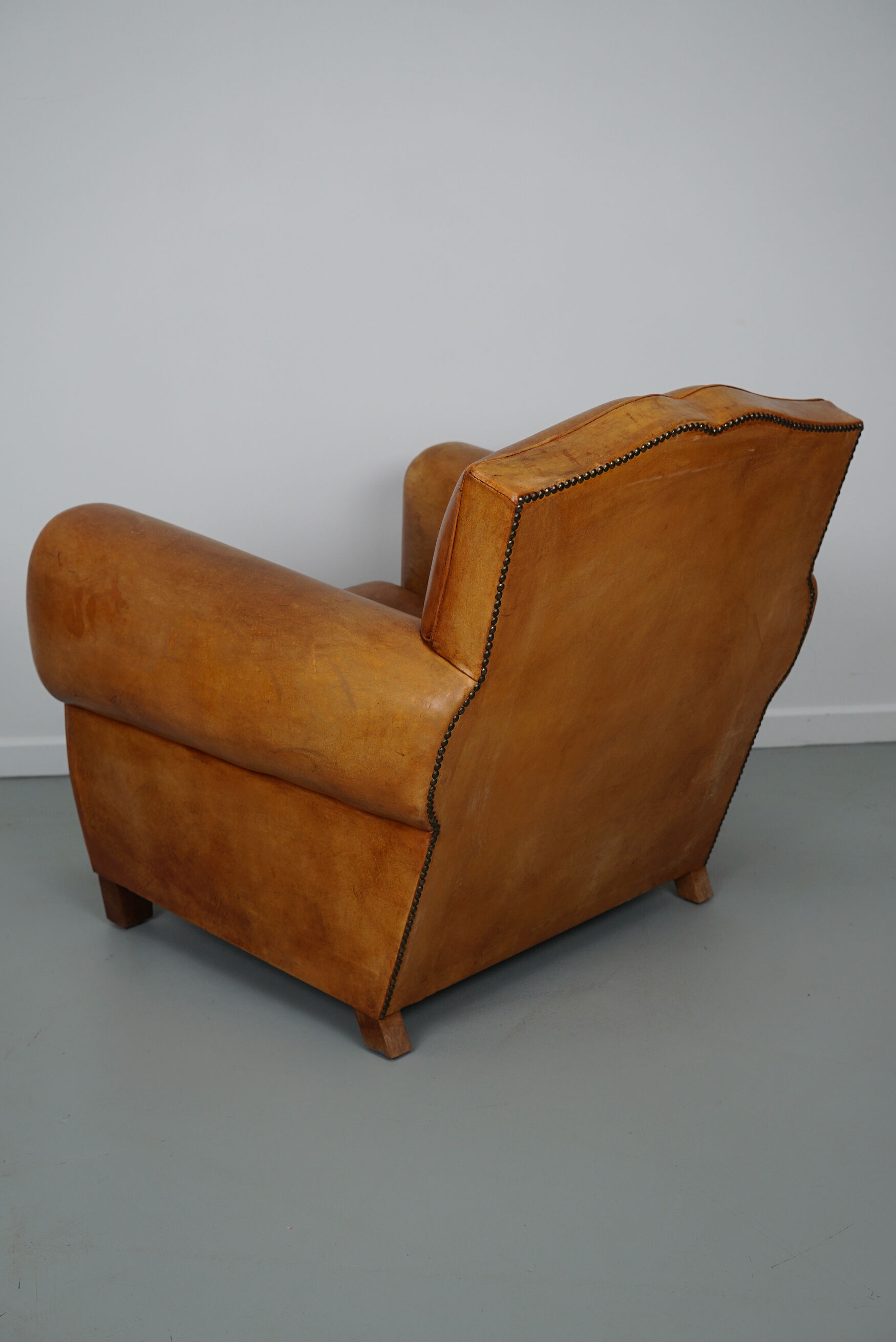 Vintage french moustache back cognac-colored leather club chair