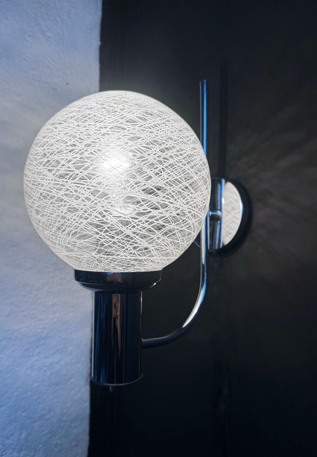 Chrome wall light with blown glass from the 1970s.