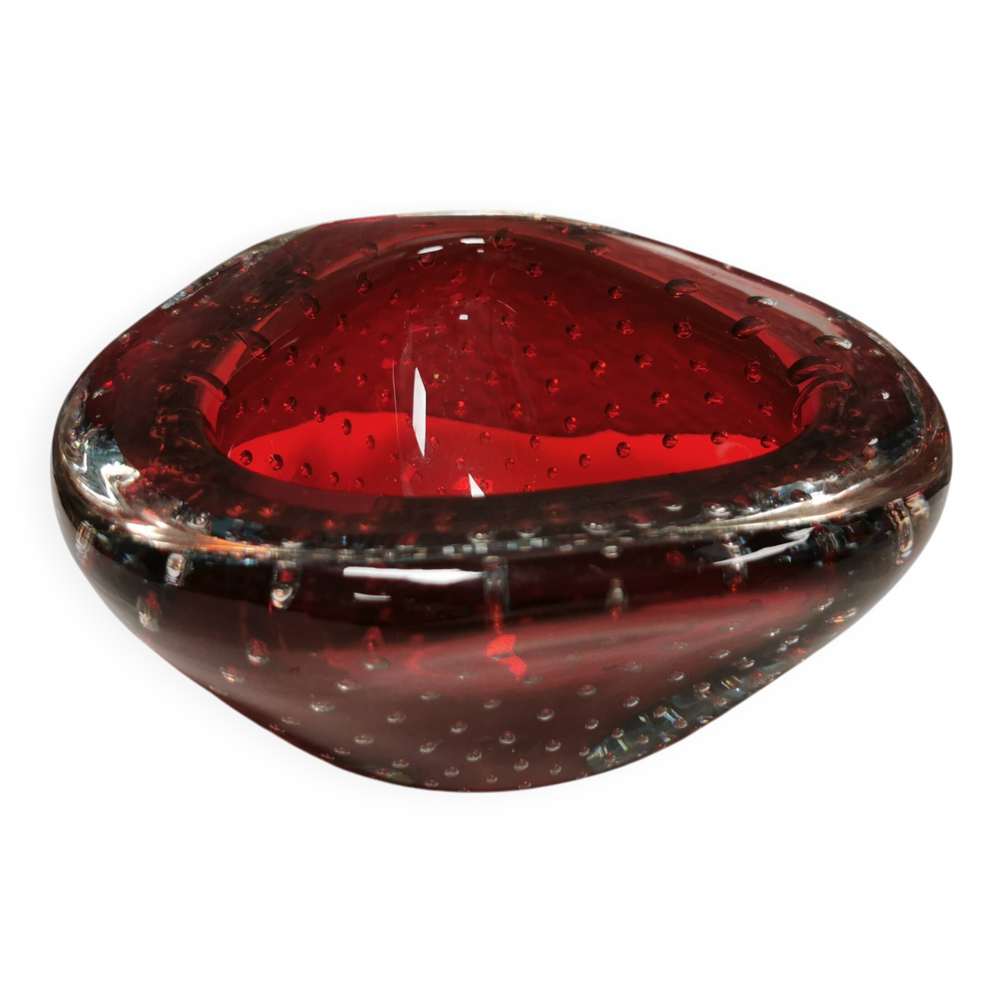 Small glass bowl in beautiful emerald red color with inlaid bubbles.