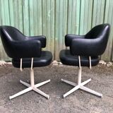 Pair of vintage armchairs in black skai with metal legs.