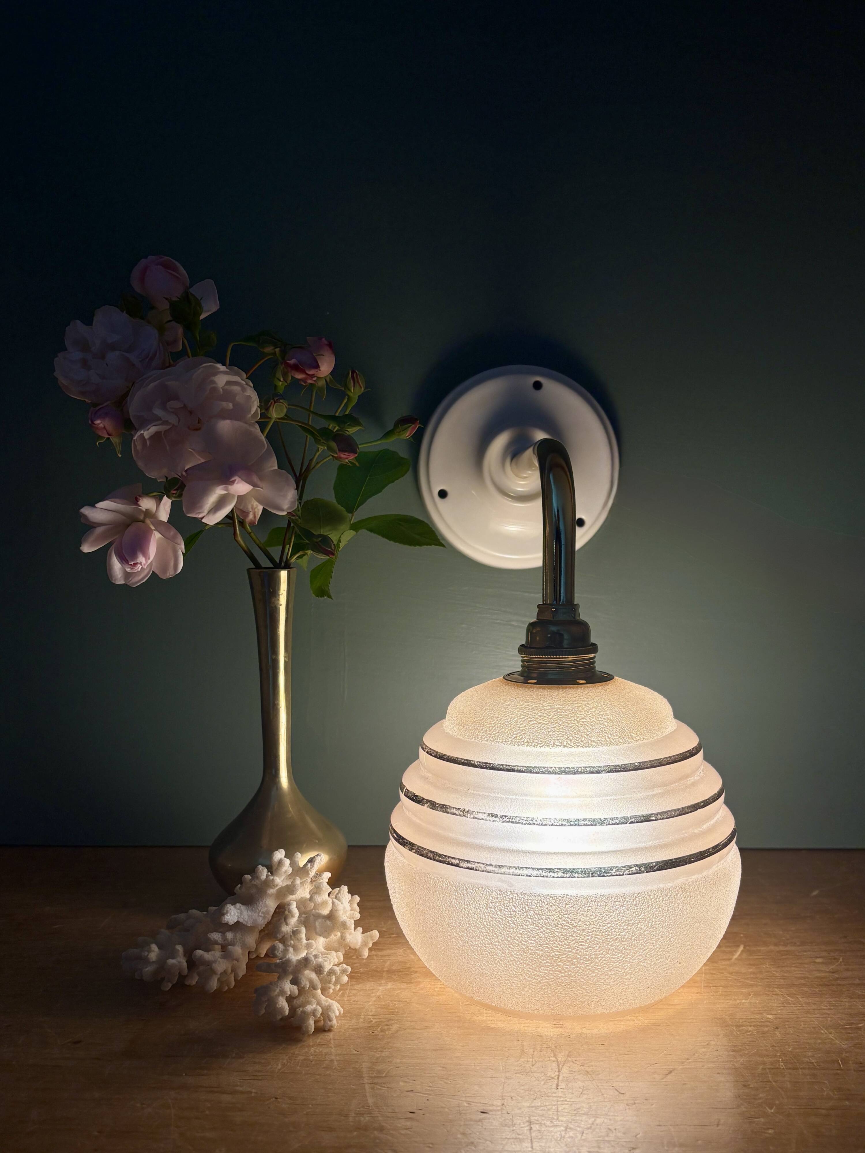Vintage pink and gold frosted glass globe wall light.
